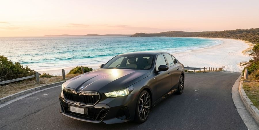 Premium executive sedan at a South Coast beach at sunset