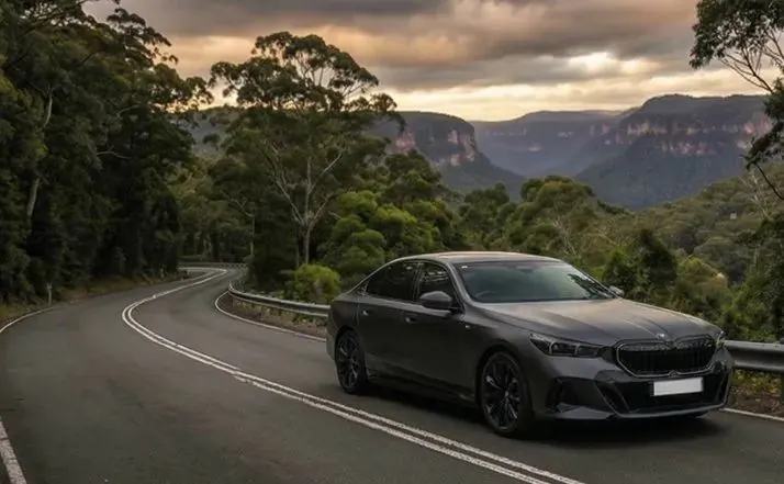 OSPIPO premium executive sedan in Frozen Deep Grey, exterior front three-quarter view