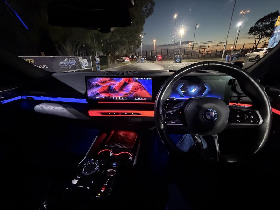 premium executive sedan cockpit with ambient lighting and curved display